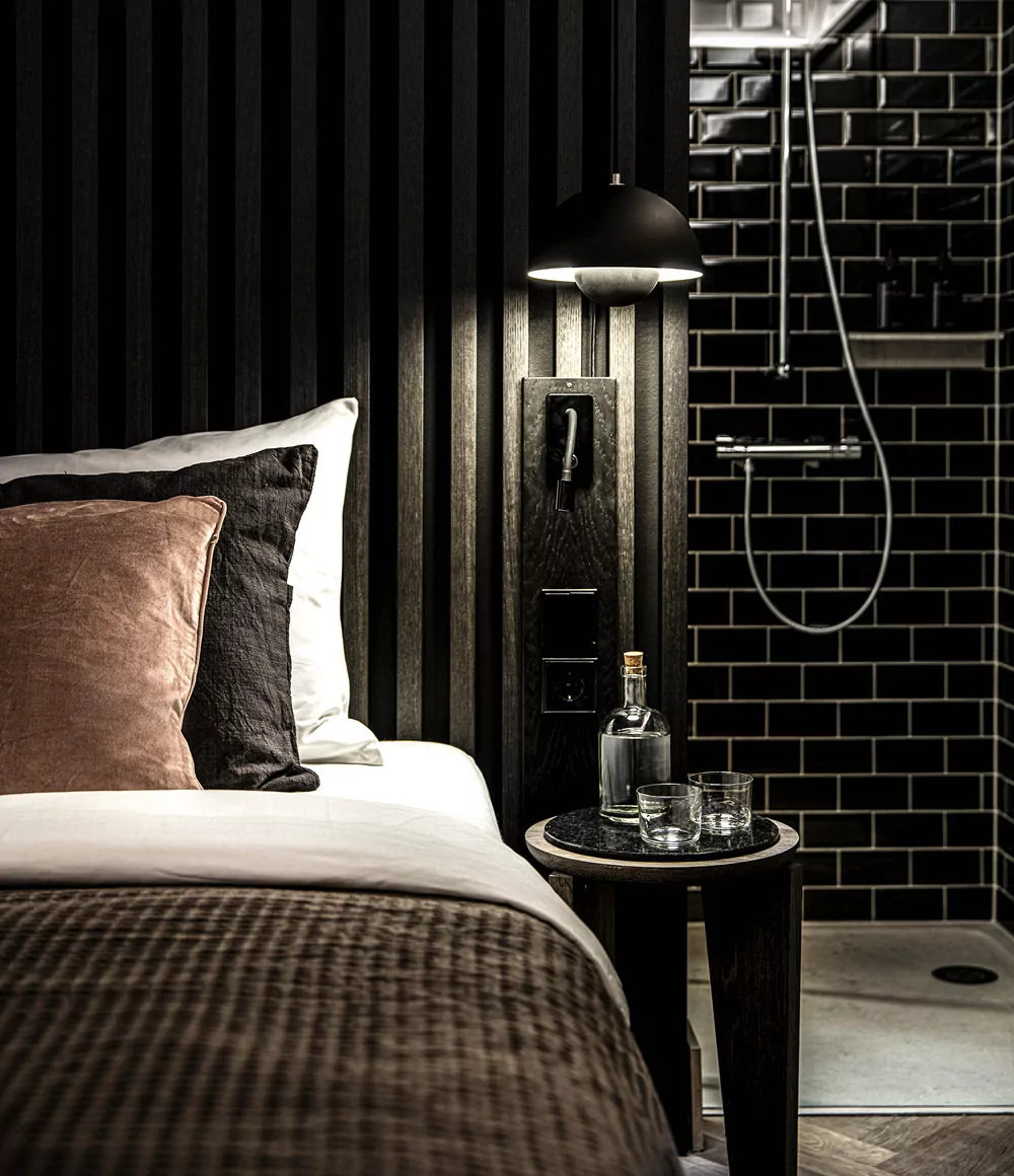 bedroom with black wooden wall