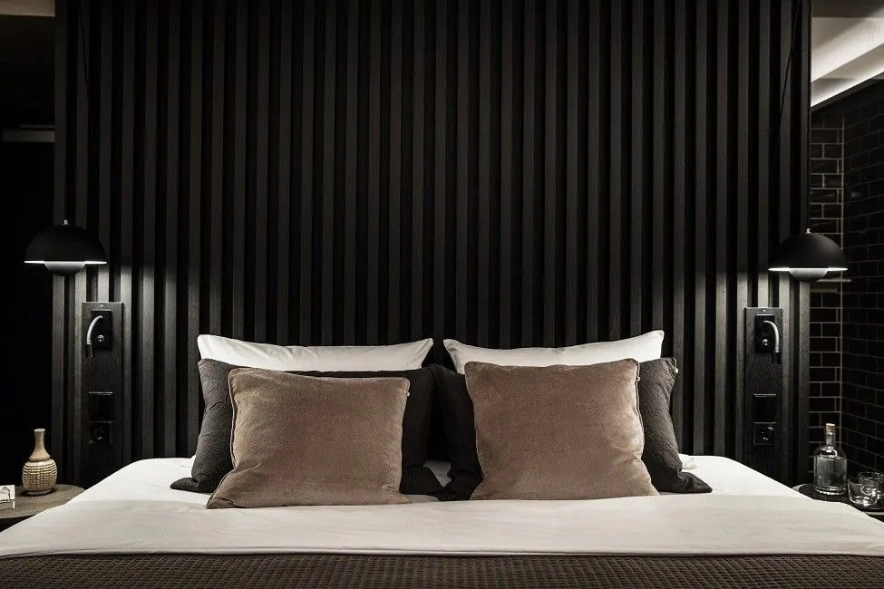 bedroom with black wooden stud wall
